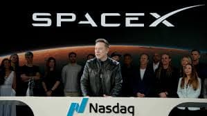SpaceX branding behind Elon Musk at a podium